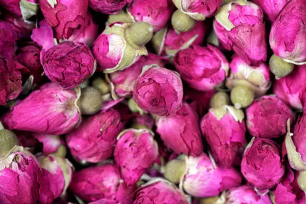 Rose tea - dried rosebuds flowers texture closeup. Dry roses petals for Asian tea and spices. Copyspace for element or background.