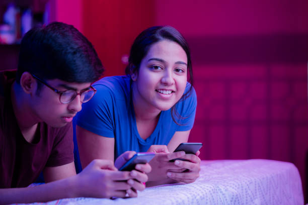 istock Brother and sister using phone 1272448641