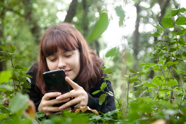 istock Young woman resting in the forest 1272449108