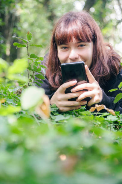 istock Young woman resting in the forest 1272449115