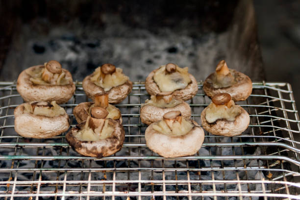 istock Mushrooms with cheese grilled on barbecue grill 1272454320