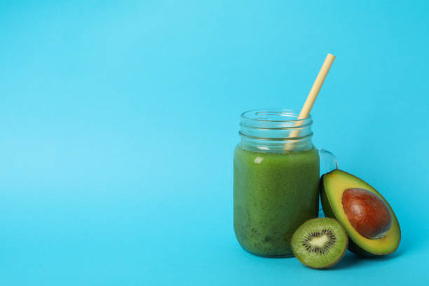 istock Smoothie, avocado and kiwi on blue background 1272455788