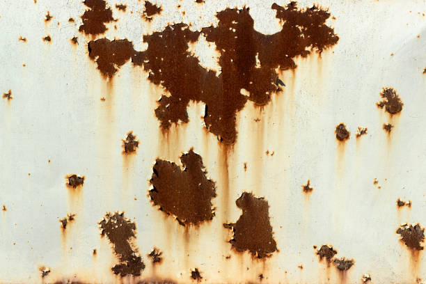 istock Rusty metal background under peeled paint 1272456129