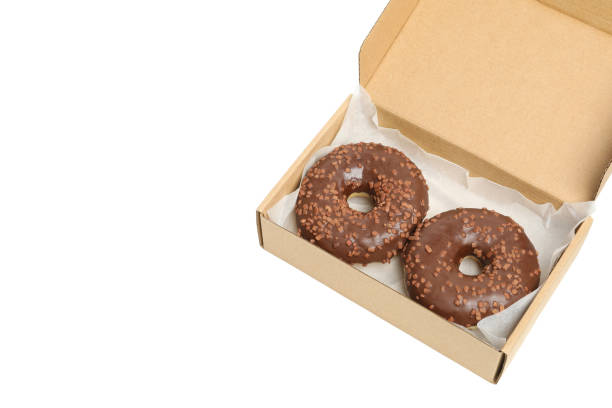 istock Carton box with donuts isolated on white background 1272457456
