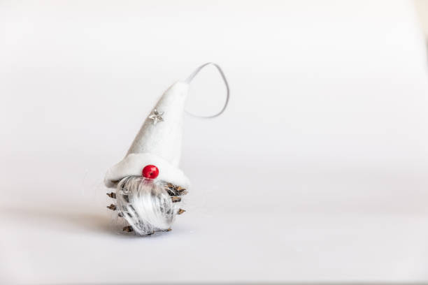 Troll, Long Hat. Christmas decorations. small gnome on a white isolated background. dwarf gnome with a red nose and a large cap covering the eyes. Copy Space