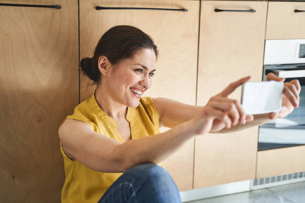 istock Joyous attractive young Caucasian woman taking selfies 1272458735