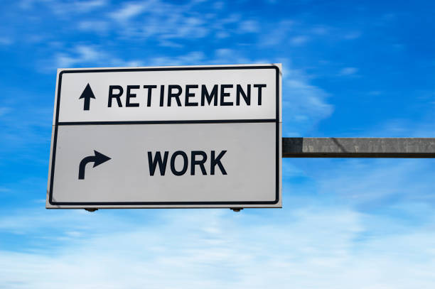 istock Retirement versus work white metal road sign on blue sky background. 1272458808