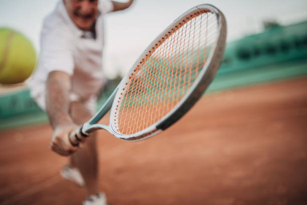 istock Senior man playing tennis 1272459035