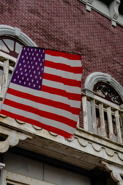 istock American flag in front of old style building 1272459440