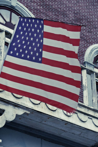 istock American flag in front of old style building 1272459795