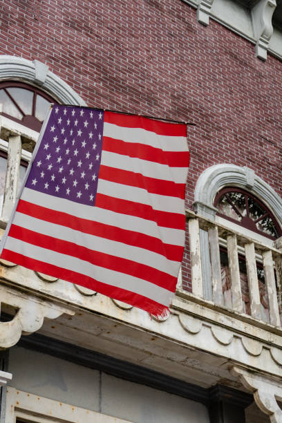 istock American flag in front of old style building 1272459897