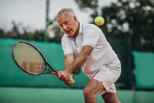 istock Senior man playing tennis 1272460143