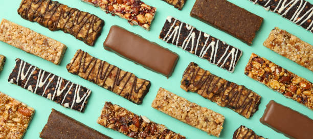 istock Flat lay with tasty granola bars on mint background, top view 1272460145