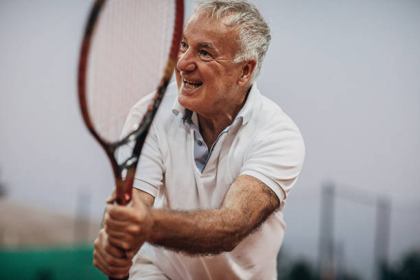 istock Senior man playing tennis 1272460286
