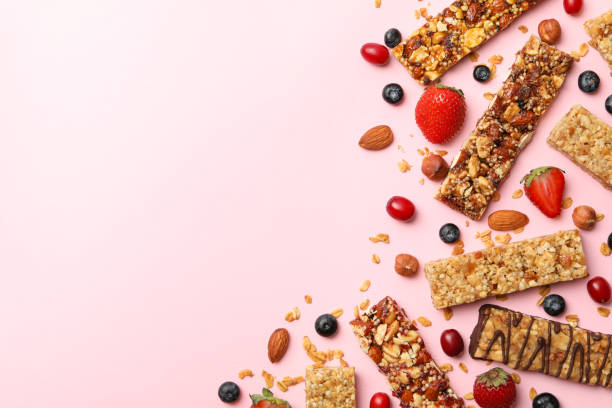 istock Tasty granola bars on pink background, top view 1272460288