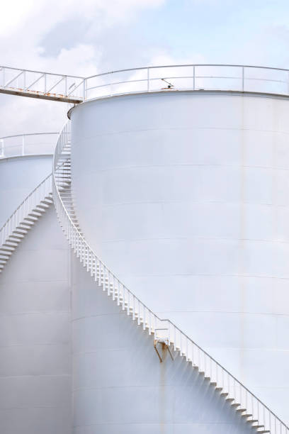 spiral staircases on white storage fuel tanks in vertical frame