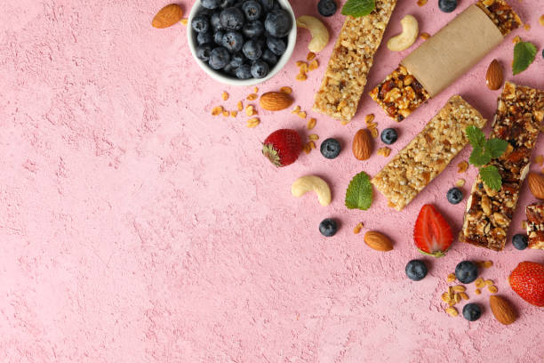 istock Granola bars and bowl with blueberry on pink background, top view 1272461134