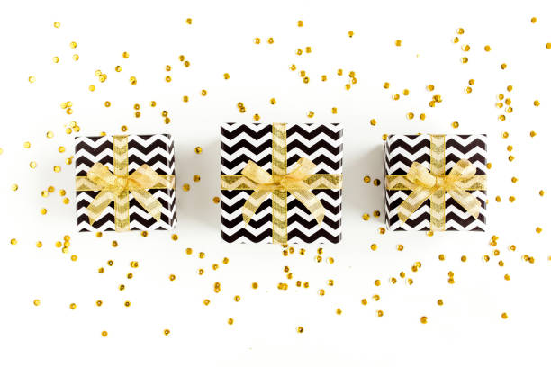 istock Gift or present boxes and stars confetti on a white background. Colorful celebration, birthday. Christmas or New Year pattern. Flat lay, top view 1272461194