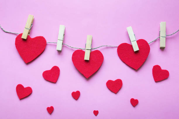 istock Handmade  hearts from red felt pinned on rope. Copy space 1272462757
