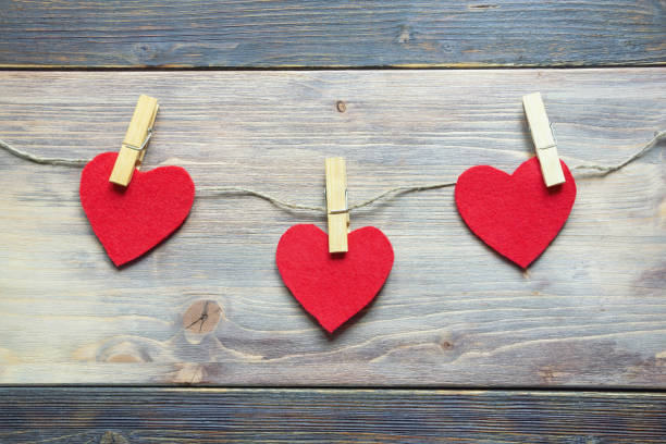 istock Handmade  hearts from red felt pinned on rope. Copy space 1272462773