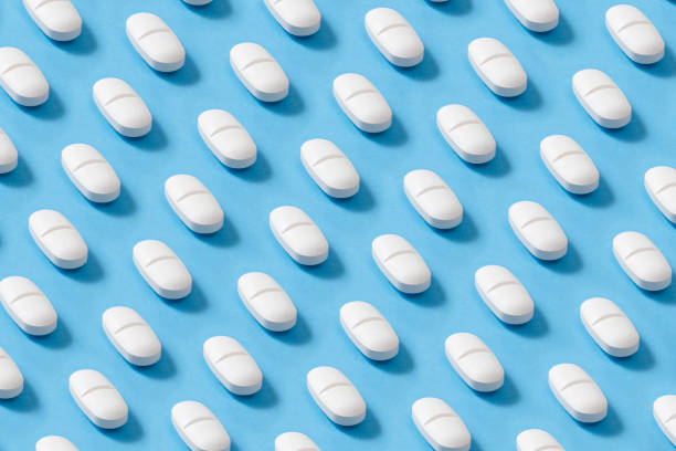 istock Pills in a Row on Blue Background 1272462833