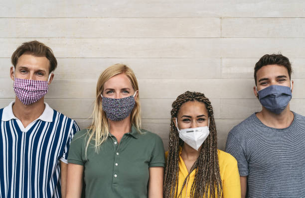 istock Friends wearing face protective mask to avoid corona virus spread - Young millennial people portrait during coronavirus outbreak - Health care people and youth multiracial lifestyle friendship concept 1272462996