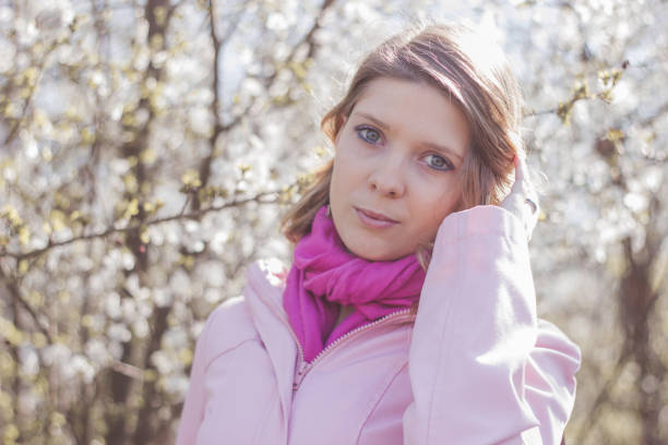 istock Female posing in front of blooming trees 1272465762