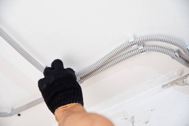 istock Electrician fixing electric cable to the wall, closeup 1272466832