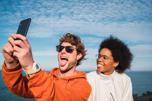 istock Two friends taking a selfie with smartpone. 1272467049