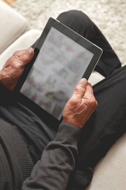 istock Senior holding a tablet in hands 1272468369