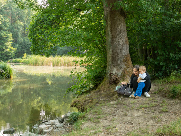 istock Mother and son watching beautiful lake 1272468414