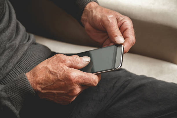 istock Senior with a cell phone 1272469321