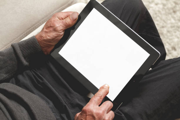 istock Senior holding a tablet in hands 1272469393