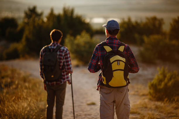istock two men hikers enjoy a walk in nature, sunset time in summer 1272469767