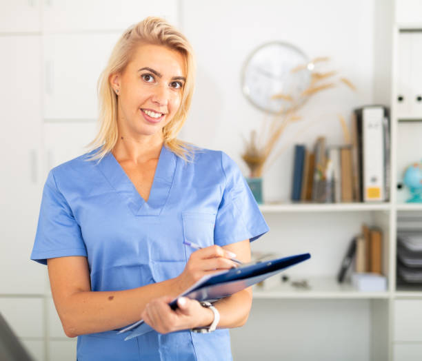 istock Positive woman doctor is standing with documents 1272471149