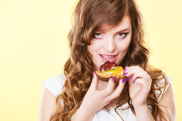istock Smiling cute woman holds fruit cake in hand 1272472170