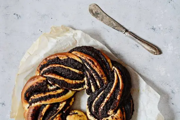 Photo of Estonian Kringle. Brioche with poppy and chocolate. Wreath. Baking, national pastries. Babka.