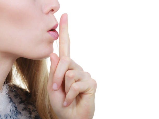 istock Woman making silence gesture with finger 1272472678