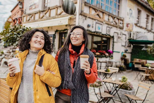 istock Two female friends having fun outdoors during winter 1272472895
