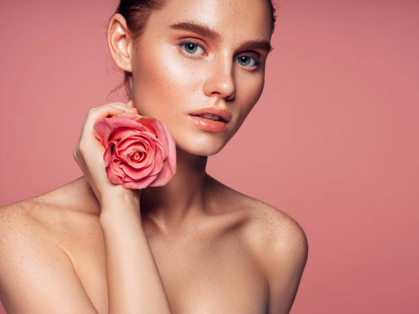 istock Beautiful woman with rose. Natural soft make-up. 1272475959
