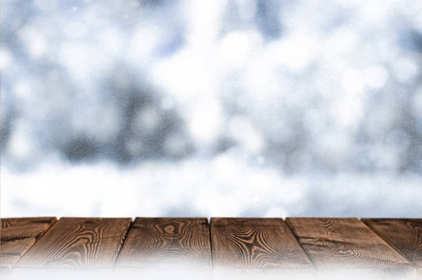 istock Christmas background with wood table top and snowfall 1272476922