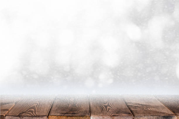istock Christmas background with wood table top and snowfall 1272476923