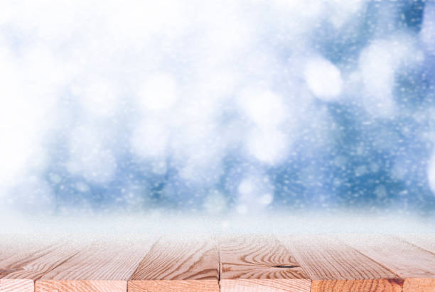 istock Christmas background with wood table top and snowfall 1272476924