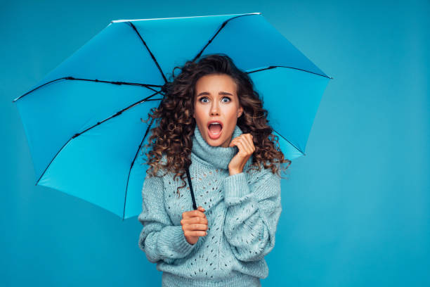 istock Girl with blue umbrella 1272477198