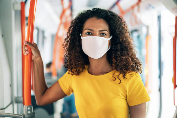 istock Woman with mask in the bus 1272477377