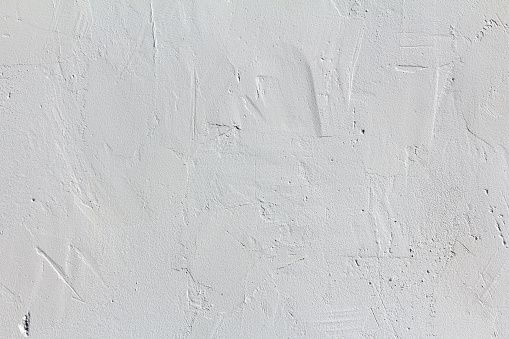 Elegant concrete wall with uneven artistic plaster