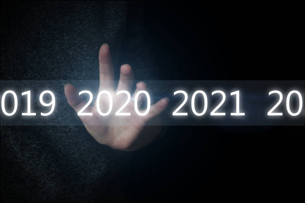 istock Luminous 2020 year numbers and network above hand at black background. New 2020 year technology concept. 1272477578