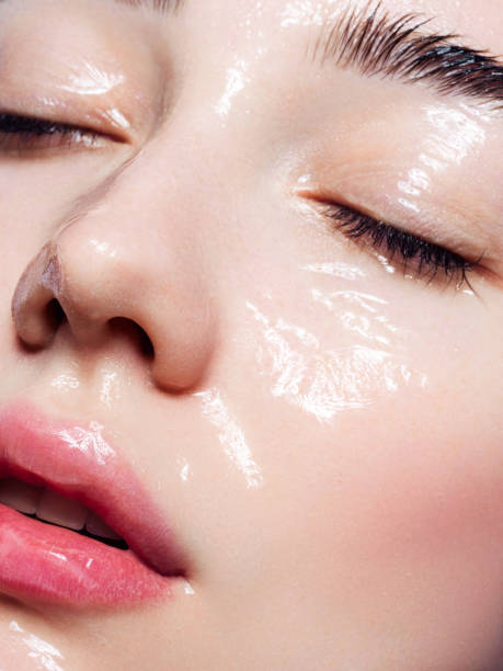 beautiful young woman with moisturizing gel on her face - portrait vertical close up female imagens e fotografias de stock