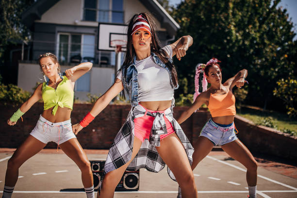 istock Modern young female dancers dancing outdoors on a sunny summer day 1272480055