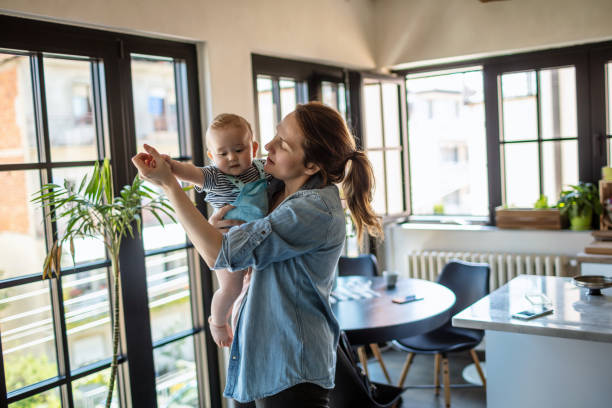 Dancing with my baby Photo of a baby boy and his mom having fun at home.They are dancing together in the living room. baby boy dancing with his mommy stock pictures, royalty-free photos & images